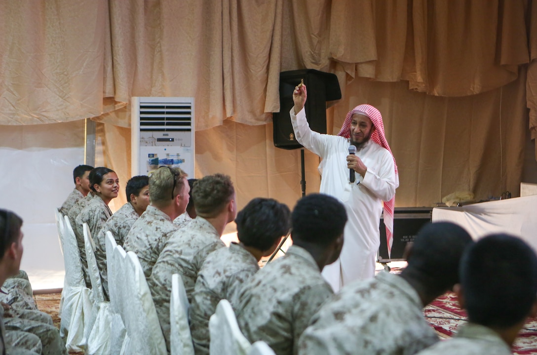 Nasser A. Alhussein, a cultural guide, gives a presentation to U.S. Marines participating in exercise Native Fury 22 during a cultural day at a Logistics Support Area established in the Kingdom of Saudi Arabia, Aug. 16, 2022. Native Fury 22 is a biennial exercise focused on the demonstration of the rapid offload and integration of a Maritime Prepositioned Force in the U.S. Central Command area of responsibility in support of regional security, crisis response, and contingency operations. (U.S. Marine Corps photo by Sgt. Alize Sotelo)