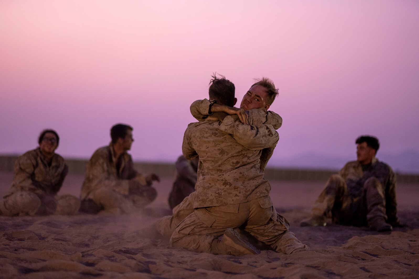 U.S. Marine Corps 2nd Lt. Arthur Deal, left, a Communication Strategy and Operations officer, and Sgt. Joshua McDaniel, right, a ground radio technician, both with Combat Logistics Regiment 1, 1st Marine Logistics Group, grapple during Marine Corps martial arts belt advancement training at a Logistics Support Area established in the Kingdom of Saudi Arabia during exercise Native Fury 22