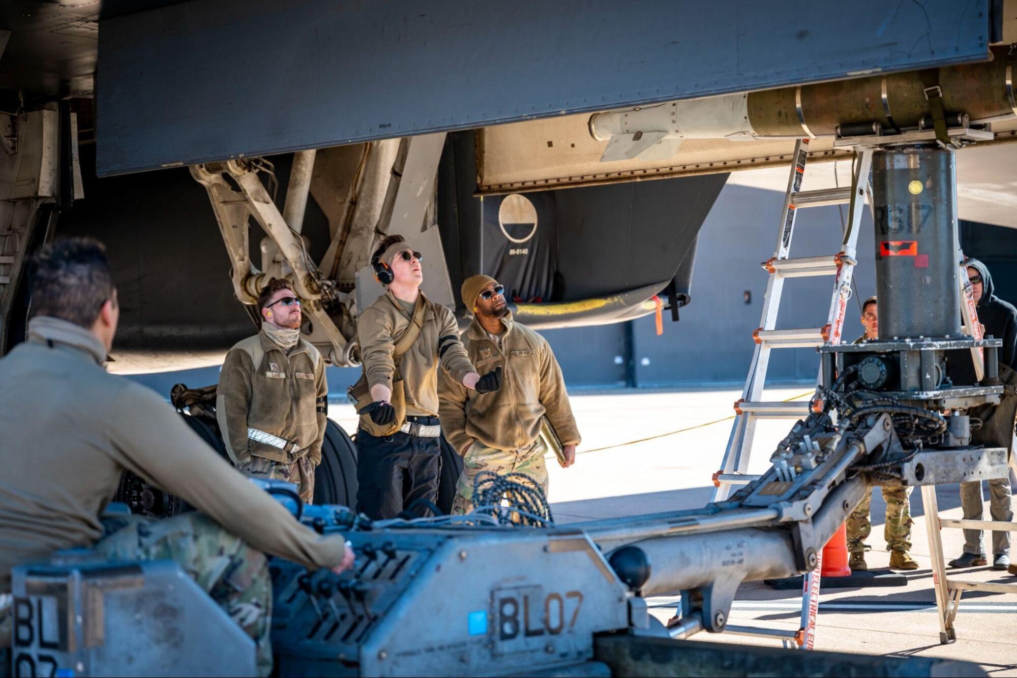 A weapons load crew member assigned to the 9th Aircraft Maintenance Unit, transports an inert bomb to a B-1B Lancer during the Load Crew of the Year competition at Dyess Air Force Base, Texas, Jan. 27, 2023. Load competitions aim to boost morale, celebrate Airmanship and promote teamwork among maintenance and munitions professionals. (U.S. Air Force photo by Senior Airman Leon Redfern)