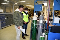 Choe, Chae-hun, right, safety and occupational health specialist for the U.S. Army Medical Materiel Center-Korea, conducts a site inspection. USAMMC-K was recently recognized by Army Materiel Command with its Exceptional Organization Safety Award at the battalion level.