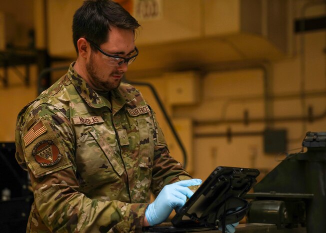 U.S. Air Force Airman Mathew Nicholas, 9th Maintenance Squadron aerospace propulsion technician, refers to the technical order (TO),  Jan. 12, 2023, at Beale Air Force Base, Calif.