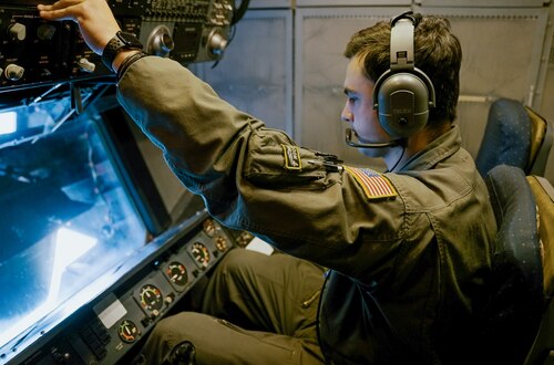 Color photo of Reserve Citizen Airmen, SSgt. Jared Breaux, 70th ARS, checking the operations window on board a KC-10A Extender aircraft.
