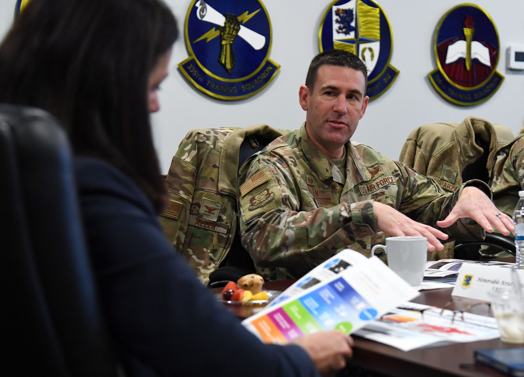 U.S. Air Force Col. Jason Allen, 81st Training Wing commander, provides a wing mission brief to the Honorable Kristyn Jones, Assistant Secretary of the Air Force financial management and comptroller, inside the 81st TRW headquarters building at Keesler Air Force Base, Mississippi, Jan. 27, 2023.