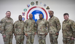 Maj. Gen. Michel M. Russell Sr., commanding general, 1st Theater Sustainment Command, Maj. Gen. David Wilson, commanding general, Army Sustainment Command, Maj. Gen. Gavin Lawrence, commanding general, Military Surface Deployment and Distribution Command, and their Command Sgts. Maj. stand for a group photo during a leader professional development conference at Camp Arifjan, Kuwait on Jan. 24, 2023.