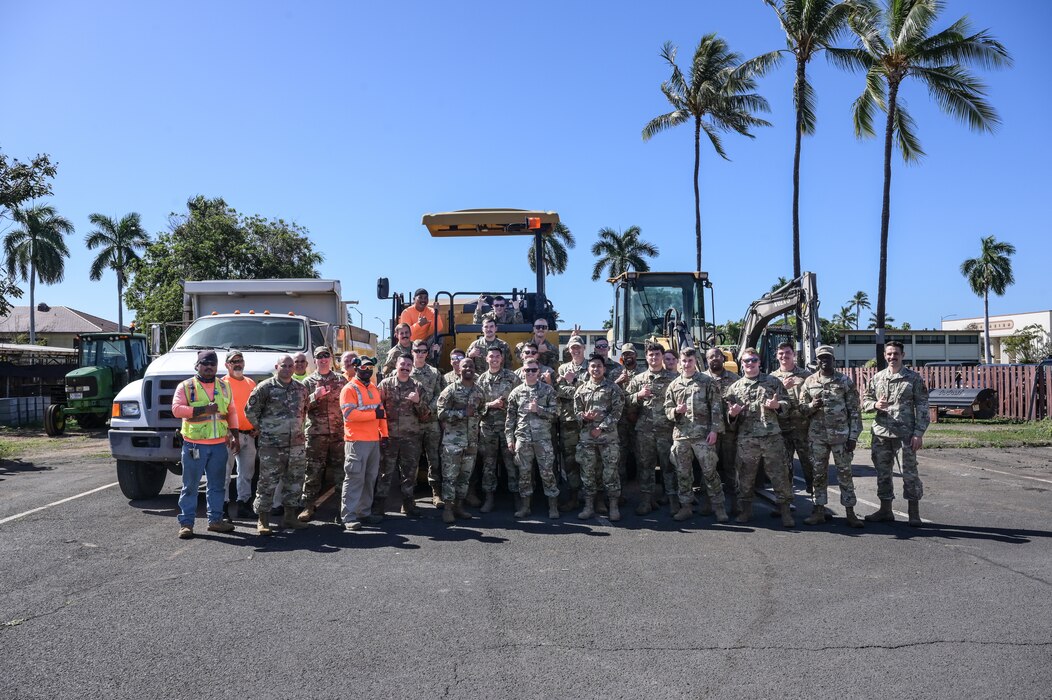 Personnel assigned to the 647th Civil Engineer Squadron pose for a photo with Chief Master Sgt. Anthony Thompson Jr., 15th Wing command chief, during an immersion tour at Joint Base Pearl Harbor-Hickam, Hawaii, Jan. 24, 2023. The squadron supports base structures, utilities, pavements and grounds, mechanical systems and explosive ordnance disposal. (U.S. Air Force photo by Senior Airman Makensie Cooper)