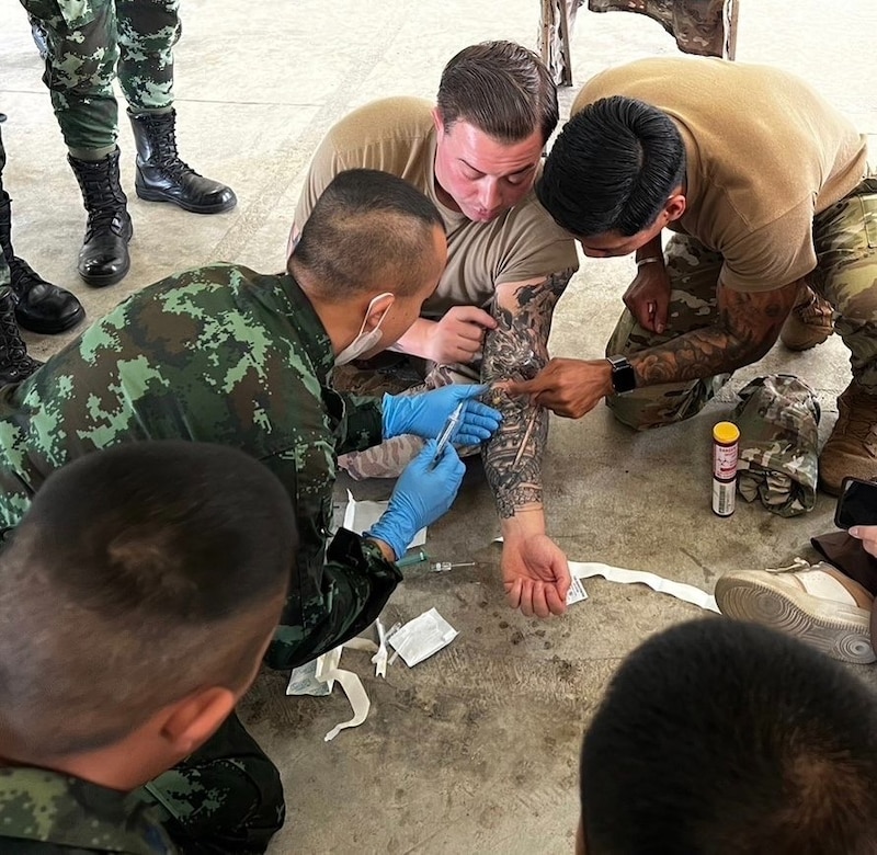 Staff Sgt. Connor Casady, health care Sgt. and Staff Sgt. Rench Simangan, Logistic Advisor, Logistic Advisor Team 5622 instructing Tactical Combat Casualty Care at 11th Maintenance Support Battalion in Chachoengsao, Thailand, Jan. 26, 2022.