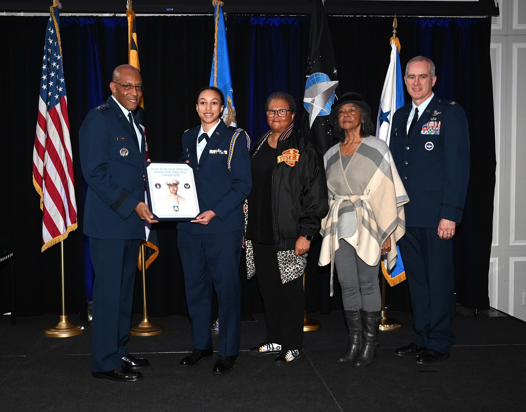 Chief of Staff of the Air Force Gen. CQ Brown, Jr., presents the Brig. Gen. Charles E. McGee Leadership Award to Cadet Cayla Williams during a ceremony at the Samuel Riggs IV Alumni Center, University of Maryland, College Park, Md., Jan 27, 2023. Members of the McGee family and University ROTC staff were also on hand.