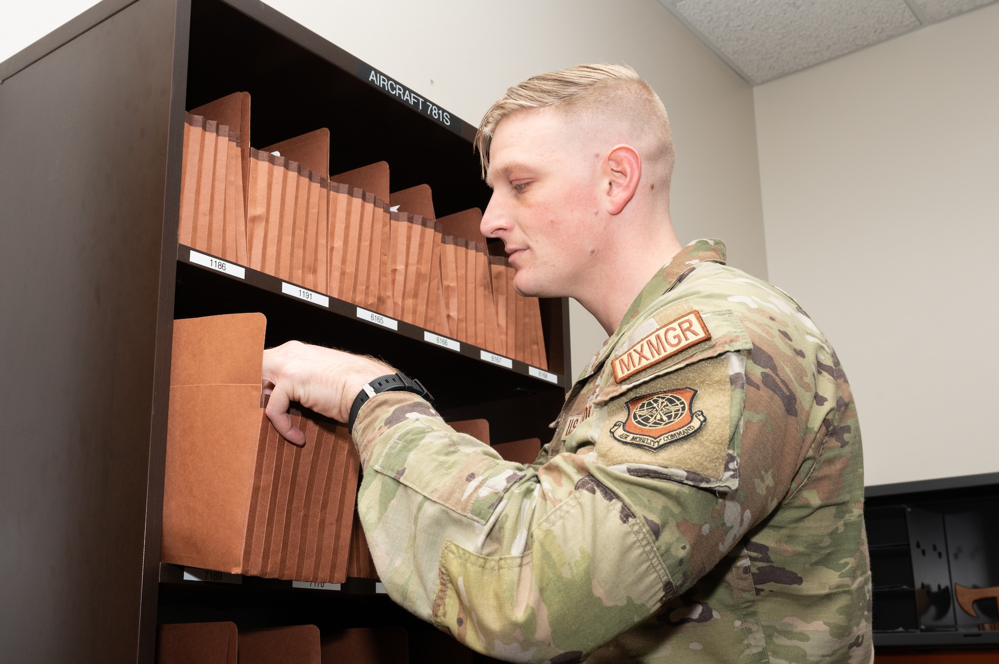 Tech. Sgt. Ethan Reterstoff, 436th Maintenance Group noncommissioned officer in charge of scheduling, reviews transcribed forms at Dover Air Force Base, Delaware, Jan. 11, 2023. The Plans and Scheduling section builds and compiles the flying and maintenance schedules for the 9th Airlift Squadron and 3rd AS. (U.S. Air Force photo by Mauricio Campino)