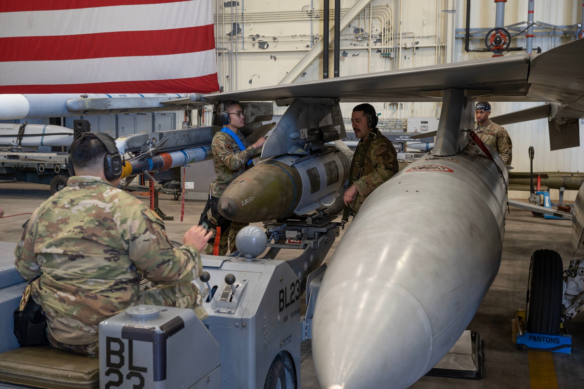 35th Fighter Generation Squadron load crew work together to load and secure a guided bomb unit-31 to a F-16 Fighting Falcon.