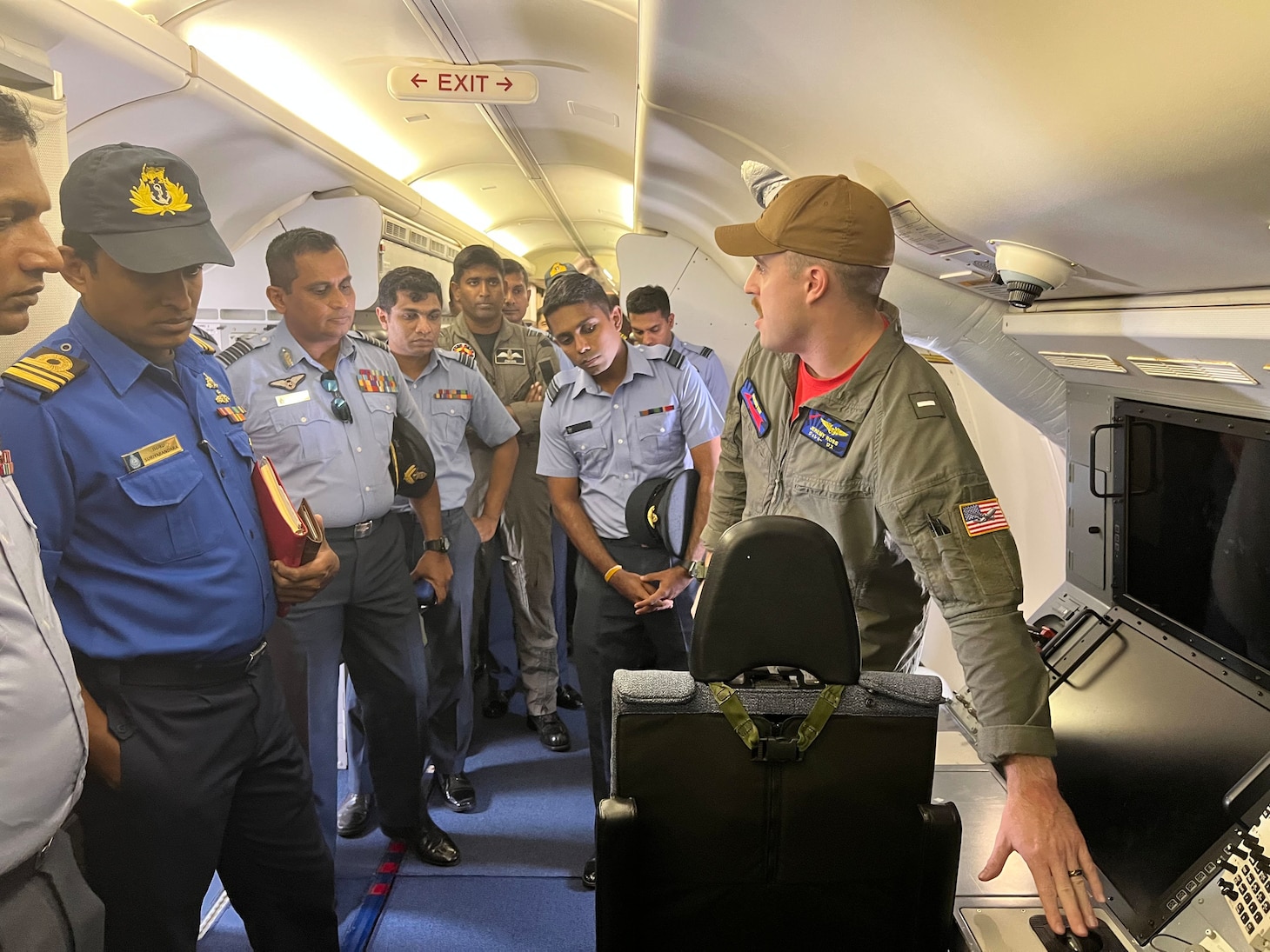 (230120-N-FY142-0006) COLOMBO, Sri Lanka (Jan. 20, 2023) – Lt. j.g. Jeremy Ross, assigned to the “Red Lancers” of Patrol Squadron (VP) 10, gives a tour of a P-8A Poseidon to members of the Sri Lanka Air Force and Navy during exercise Cooperation Afloat Readiness and Training/Marine Exercise Sri Lanka 2022. VP-10 is currently operating from Kadena Air Base in Okinawa, Japan. The squadron conducts maritime patrol and reconnaissance, as well as theater outreach operations, as part of a rotational deployment to the U.S. 7th Fleet area of operations. (U.S. Navy photo by Lt. j.g. Brian DePaola)
