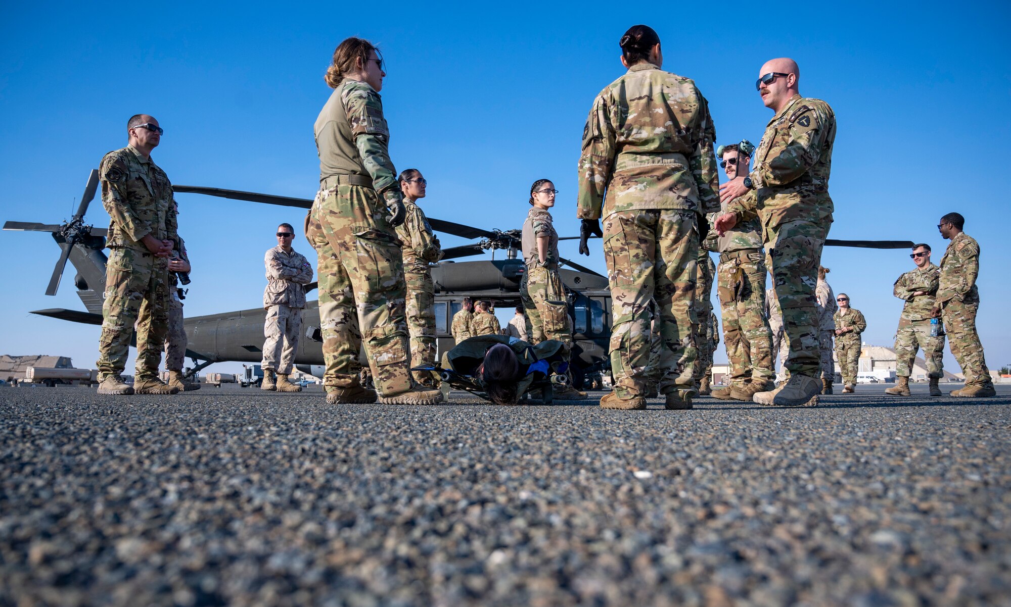 U.S. Air Force Airmen, U.S. Army Soldiers, and Canadian and Norwegian coalition partners train on how to load and unload injured patients from a UH-60 Blackhawk helicopter at Ali Al Salem Air Base, Kuwait, Jan. 20, 2023.