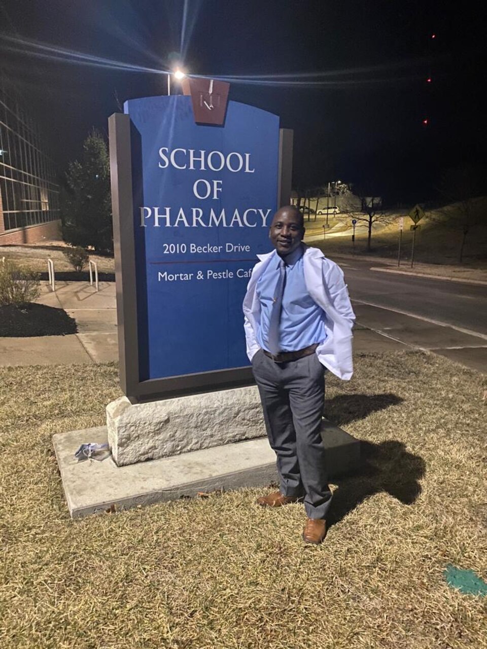 230130-N-NO901-1001 (Jan. 30, 2023) LAGOS, Nigeria - Hospital Corpsman 1st Class Agossou Marcellin, a Benin native, Pharmaceutical doctorate student, and U.S. Navy Reservist, poses for a photo in front of the University of Kansas’ School of Pharmacy. Marcellin is currently deployed to Benin in support of exercise Obangame Express 2023. Obangame Express 2023, conducted by U.S. Naval Forces Africa, is a maritime exercise designed to improve cooperation, and increase maritime safety and security among participating nations in the Gulf of Guinea and Southern Atlantic Ocean. U.S. Sixth Fleet, headquartered in Naples, Italy, conducts the full spectrum of joint and naval operations, often in concert with allied and interagency partners, in order to advance U.S. national interests and security and stability in Europe and Africa. (Courtesy Photo)
