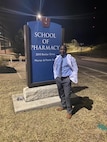 230130-N-NO901-1001 (Jan. 30, 2023) LAGOS, Nigeria - Hospital Corpsman 1st Class Agossou Marcellin, a Benin native, Pharmaceutical doctorate student, and U.S. Navy Reservist, poses for a photo in front of the University of Kansas’ School of Pharmacy. Marcellin is currently deployed to Benin in support of exercise Obangame Express 2023. Obangame Express 2023, conducted by U.S. Naval Forces Africa, is a maritime exercise designed to improve cooperation, and increase maritime safety and security among participating nations in the Gulf of Guinea and Southern Atlantic Ocean. U.S. Sixth Fleet, headquartered in Naples, Italy, conducts the full spectrum of joint and naval operations, often in concert with allied and interagency partners, in order to advance U.S. national interests and security and stability in Europe and Africa. (Courtesy Photo)