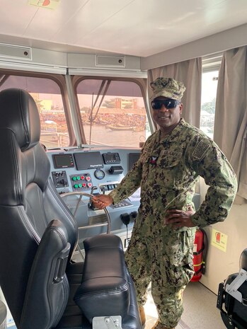 230130-N-NO901-1004 (Jan. 30, 2023) LAGOS, Nigeria - Hospital Corpsman 1st Class Agossou Marcellin, a Benin native, Pharmaceutical doctorate student, and U.S. Navy Reservist, poses for a photo on a Benin Navy ship during exercise Obangame Express 2023. Obangame Express 2023, conducted by U.S. Naval Forces Africa, is a maritime exercise designed to improve cooperation, and increase maritime safety and security among participating nations in the Gulf of Guinea and Southern Atlantic Ocean. U.S. Sixth Fleet, headquartered in Naples, Italy, conducts the full spectrum of joint and naval operations, often in concert with allied and interagency partners, in order to advance U.S. national interests and security and stability in Europe and Africa. (Courtesy Photo)