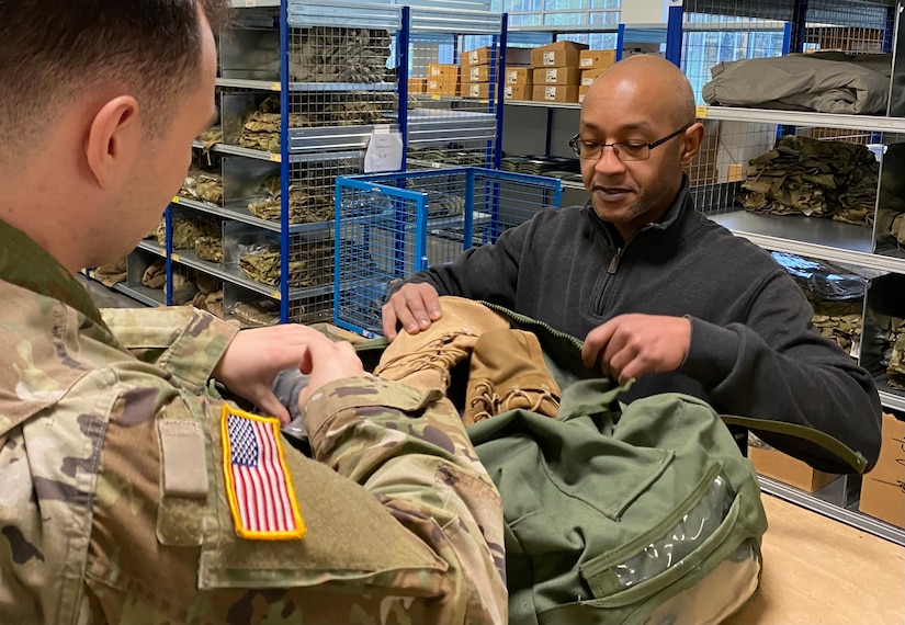 Hassan Hearne, the Central Issue Facility manager at Kleber Kaserne, assists a Soldier with his CIF issue at the facility, Jan. 30. Hearne, who is assigned to Logistics Readiness Center Rheinland-Pfalz as a supervisory supply specialist and property book officer, has been working in Army supply and at CIFs for 15 years – nearly half of that time at the Kleber facility.