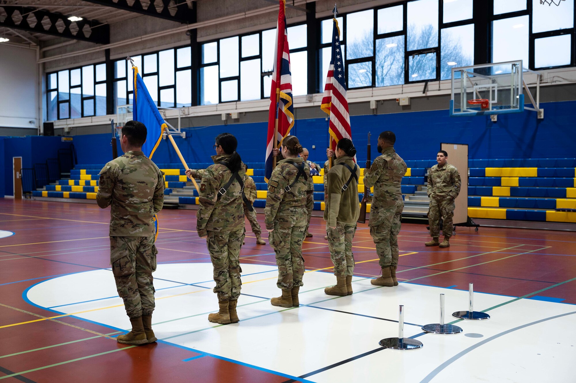 The Team Mildenhall honor guard poses for a group photo after practice at Royal Air Force Mildenhall, England, Jan. 26, 2023. The base honor guard emphasizes the importance of military customs and courtesies, dress and appearance, and drill and ceremony. (U.S. Air Force photo by Airman 1st Class Viviam Chiu)