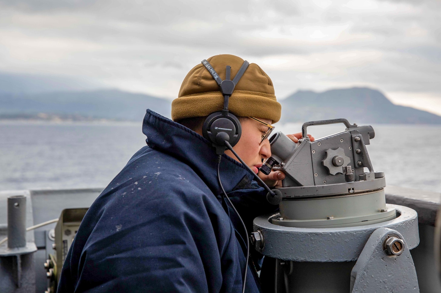 (Jan. 30, 2023) Quartermaster 3rd Class Ryan Banda, assigned to the Ticonderoga-class guided-missile cruiser USS Leyte Gulf (CG 55), stands watch on the bridge wing as the ship arrives in Souda Bay, Greece, for a scheduled port visit, Jan. 30, 2023. The George H.W. Bush Carrier Strike Group is on a scheduled deployment in the U.S. Naval Forces Europe area of operations, employed by U.S. Sixth Fleet to defend U.S., allied, and partner interests.