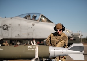U.S. Air Force Airman 1st Class Kaleb Berghoff, a munitions systems specialist assigned to the 122nd Fighter Wing, Indiana Air National Guard, prepares to load a Mark 84 bomb onto an A-10C Thunderbolt II aircraft during an Integrated Turn Combat maneuver while the pilot waits in the cockpit during Guardian Blitz exercise at Moody Air Force Base, Georgia, Jan. 26, 2023.
