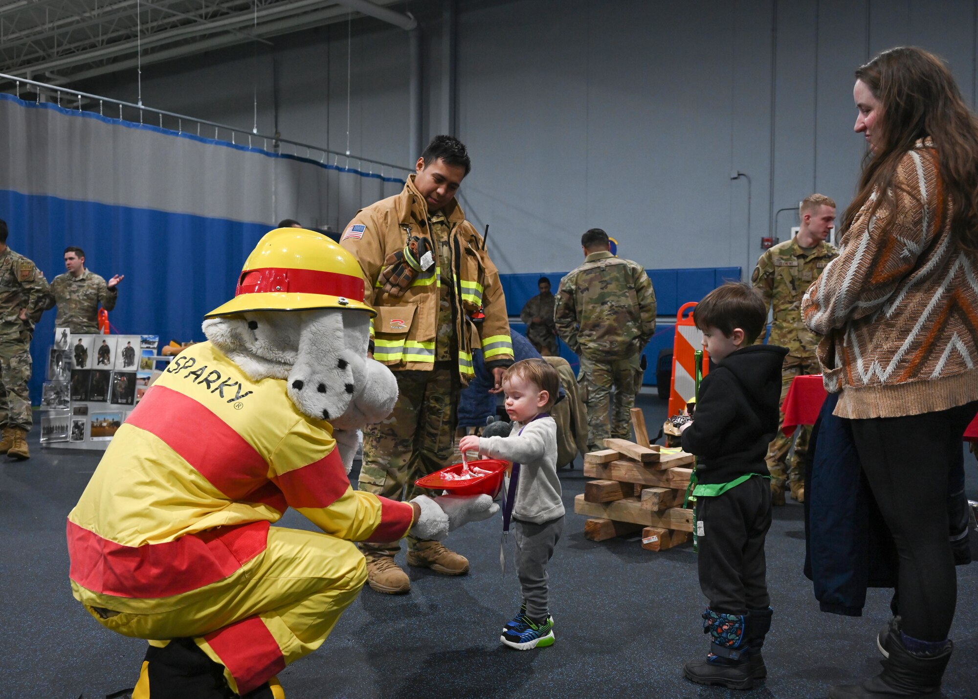 Team Minot families and their children rallied at the Community Complex Center for Operation Hero at Minot Air Force Base, North Dakota, Jan. 20, 2023. Airmen assigned to 20 different agencies from the 5th Bomb Wing and the 91st Missile Wing showcased their duties, conducted demonstrations, and provided interactive experiences to over 150 families. (U.S. Air Force photo by Senior Airman Caleb S. Kimmell)