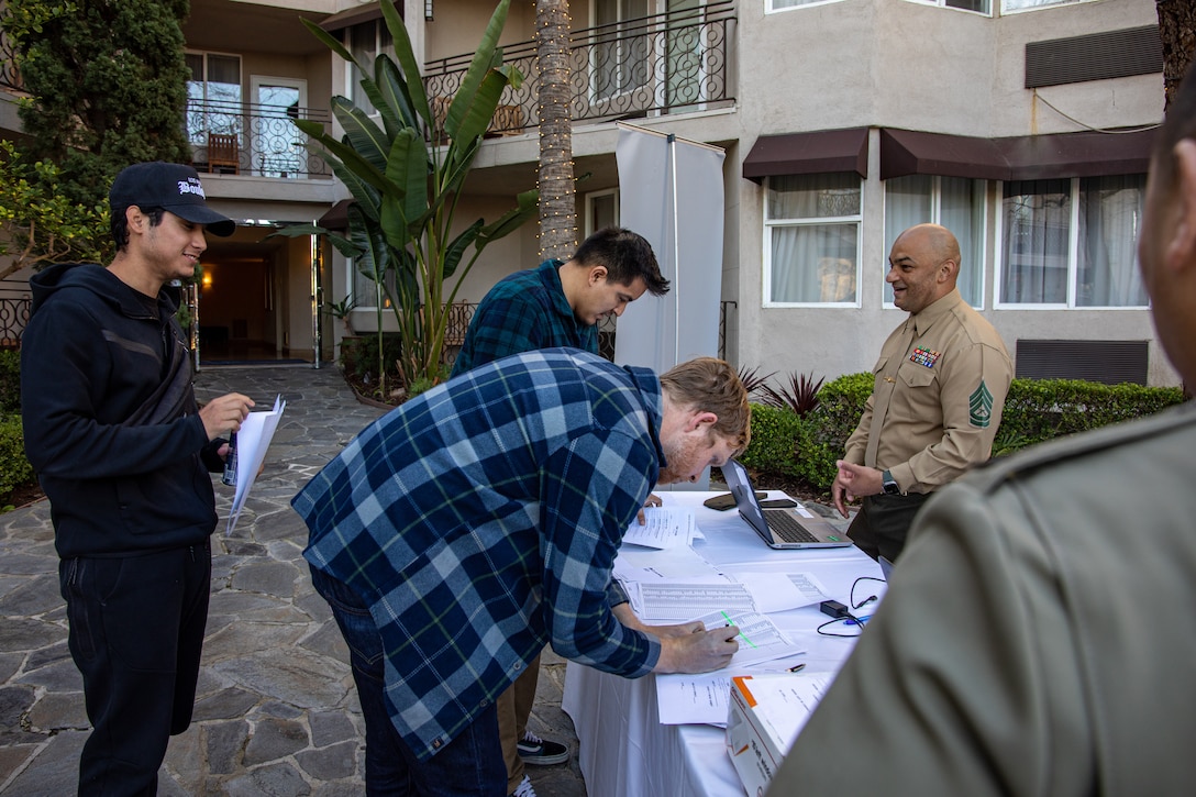 Gunnery Sgt. Kairo Ortez, an operations chief within the Marine Corps Individual Reserve Support Activity, Force Headquarters Group, Marine Forces Reserve converses with Marines in the Individual Ready Reserve (IRR) during the check-in process of an IRR Muster, Manhattan Beach, California, Jan. 21, 2023. During these musters, Marines are informed of the benefits and opportunities available to them while serving as IRR Marines. The Marines are also informed of career opportunities available to them such as a lateral move into a new military occupational specialty. (U.S. Marine Corps photo by Cpl. Jonathan L. Gonzalez)