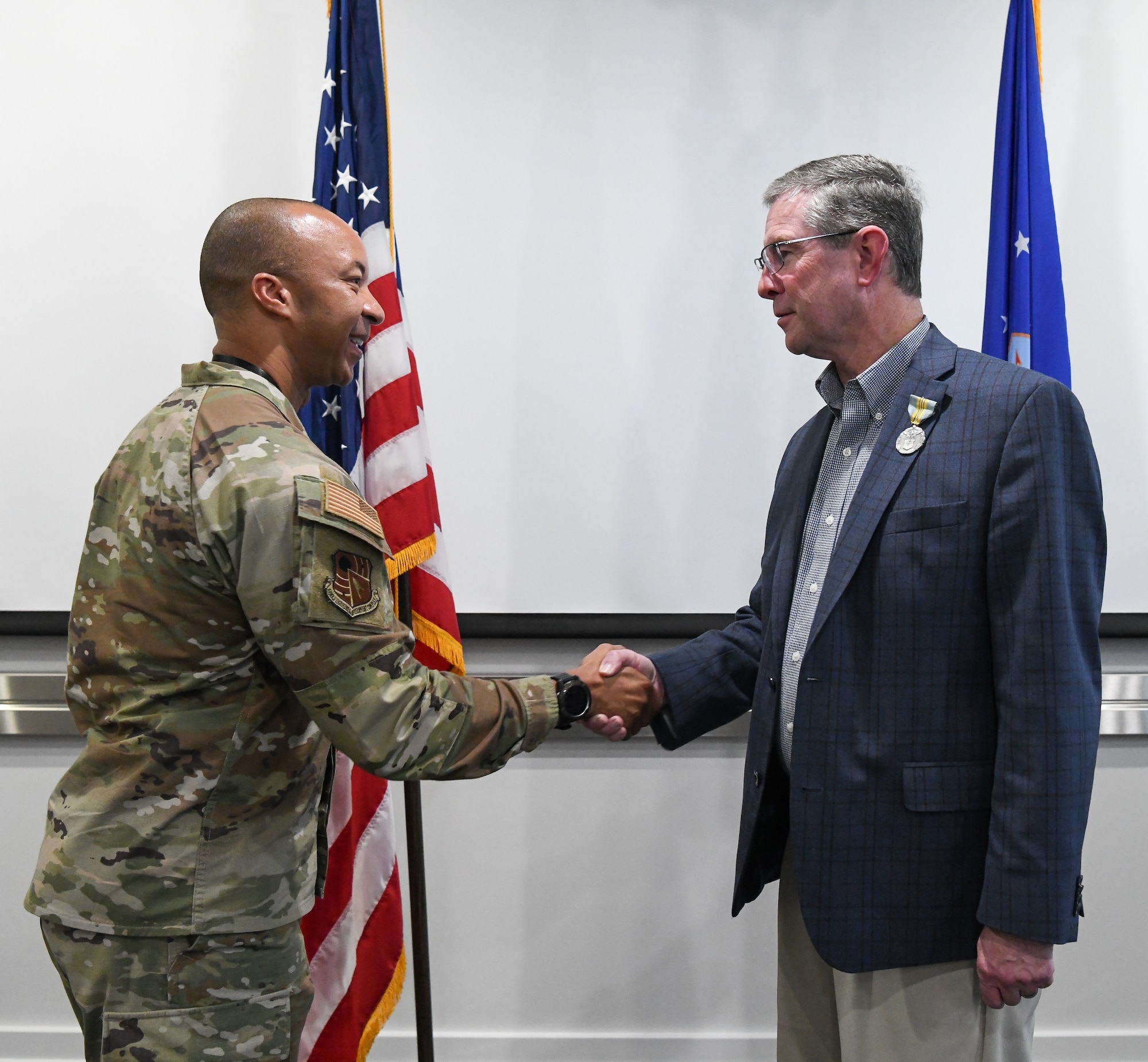 Air Force colonel shaking hands with civilian