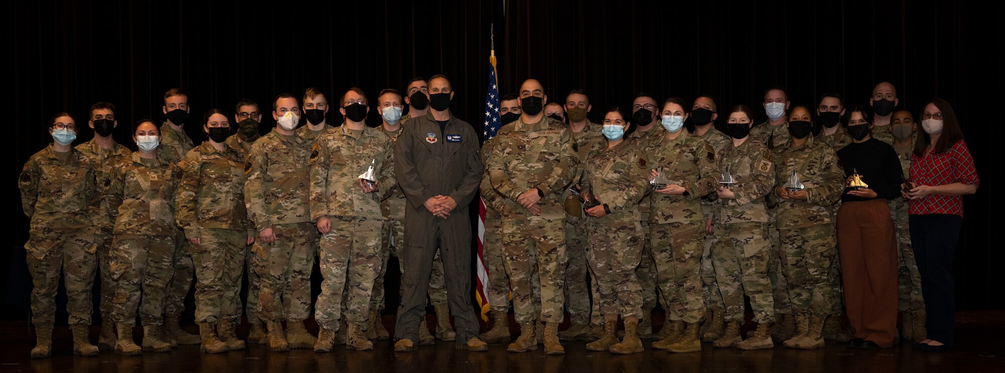 4th Fighter Wing quarterly award winners pose for a photo with Col. Lucas Teel, 4th FW commander, and Chief Master Sgt. Peter Martinez, 4th FW command chief, during the 2022 4th Quarterly Awards Ceremony at Seymour Johnson Air Force Base, North Carolina, Jan. 20, 2023. Quarterly awards are awarded to Airmen in 13 different categories, including Airman, Non-commissioned officer, guardsman, key spouse, senior non-commissioned officer and more.