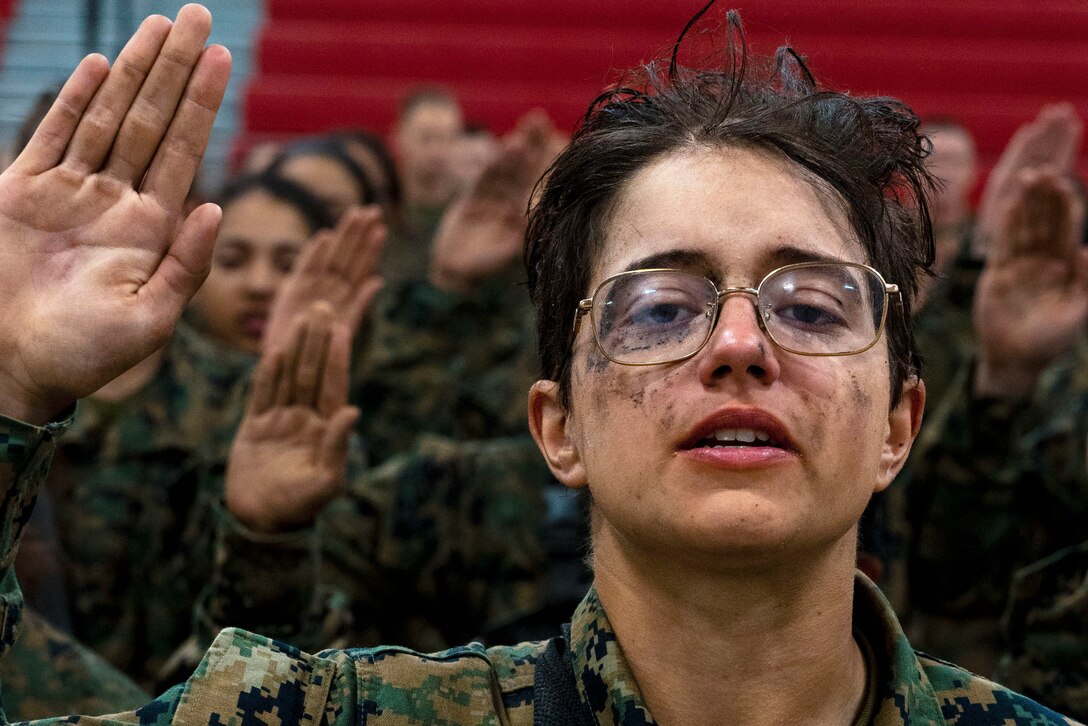 A close shot of a Marine raising their hand.