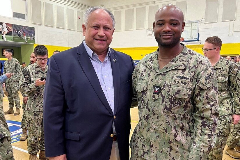 Two men pose for a photo.