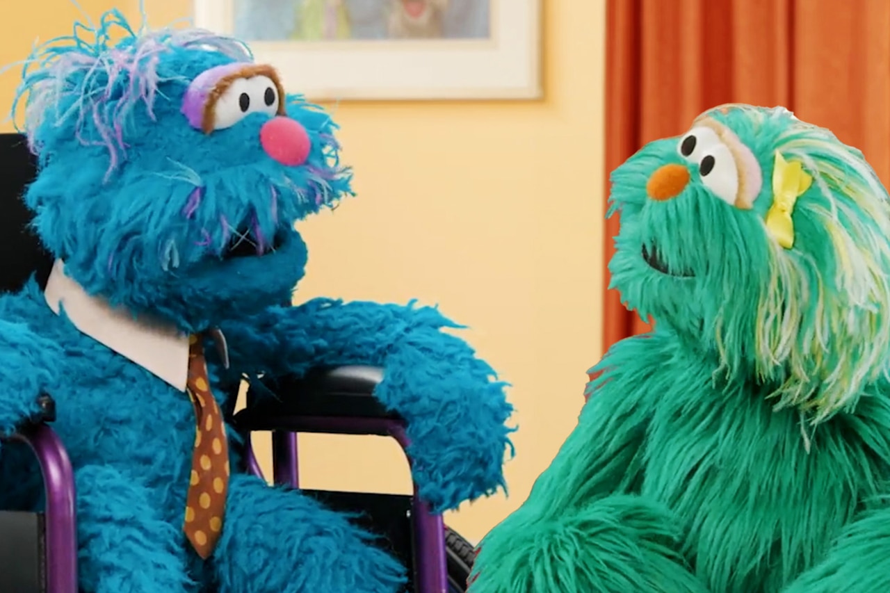 Two Muppets, one of whom is in a wheelchair, talk.