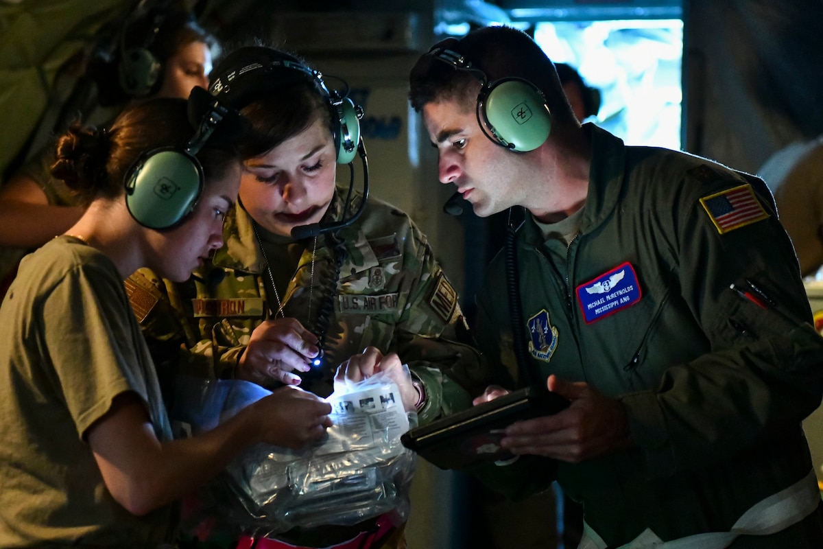 Airmen assigned to the 183rd Aeromedical Evacuation Squadron search for medical supplies to care for a simulated patient aboard a KC-135 Stratotanker, June 22. The Airmen completed their annual training, where they honed their skills in patient care at MacDill Air Force Base. (U.S. Air National Guard photo by 1st Lt. Kiara N. Spann)
