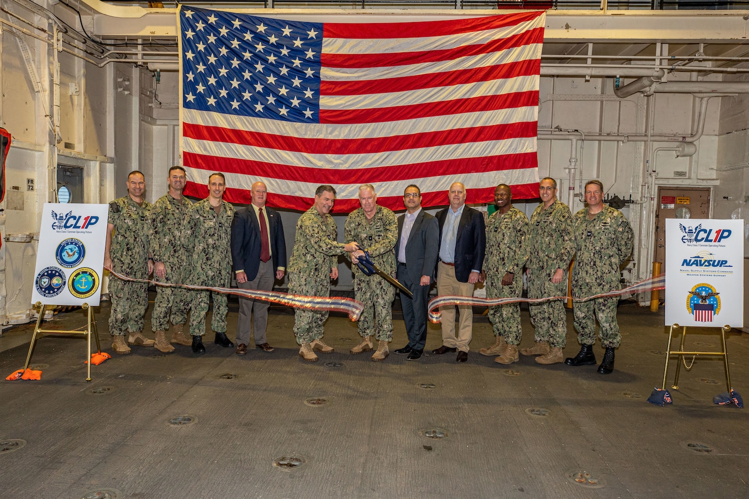 Navy leaders and industry partners celebrate the launch of the Class 1 Common Operating Picture (CL1P) aboard USNS Robert E Peary (T-AKE 5) Jan. 24. The Navy partnered strategic industries like Four Inc, IBM and Cubewise to develop CL1P, a program to optimize fleet readiness. (U.S. Navy Photo by Mass Communication Specialist 2nd Class Conner Foy)