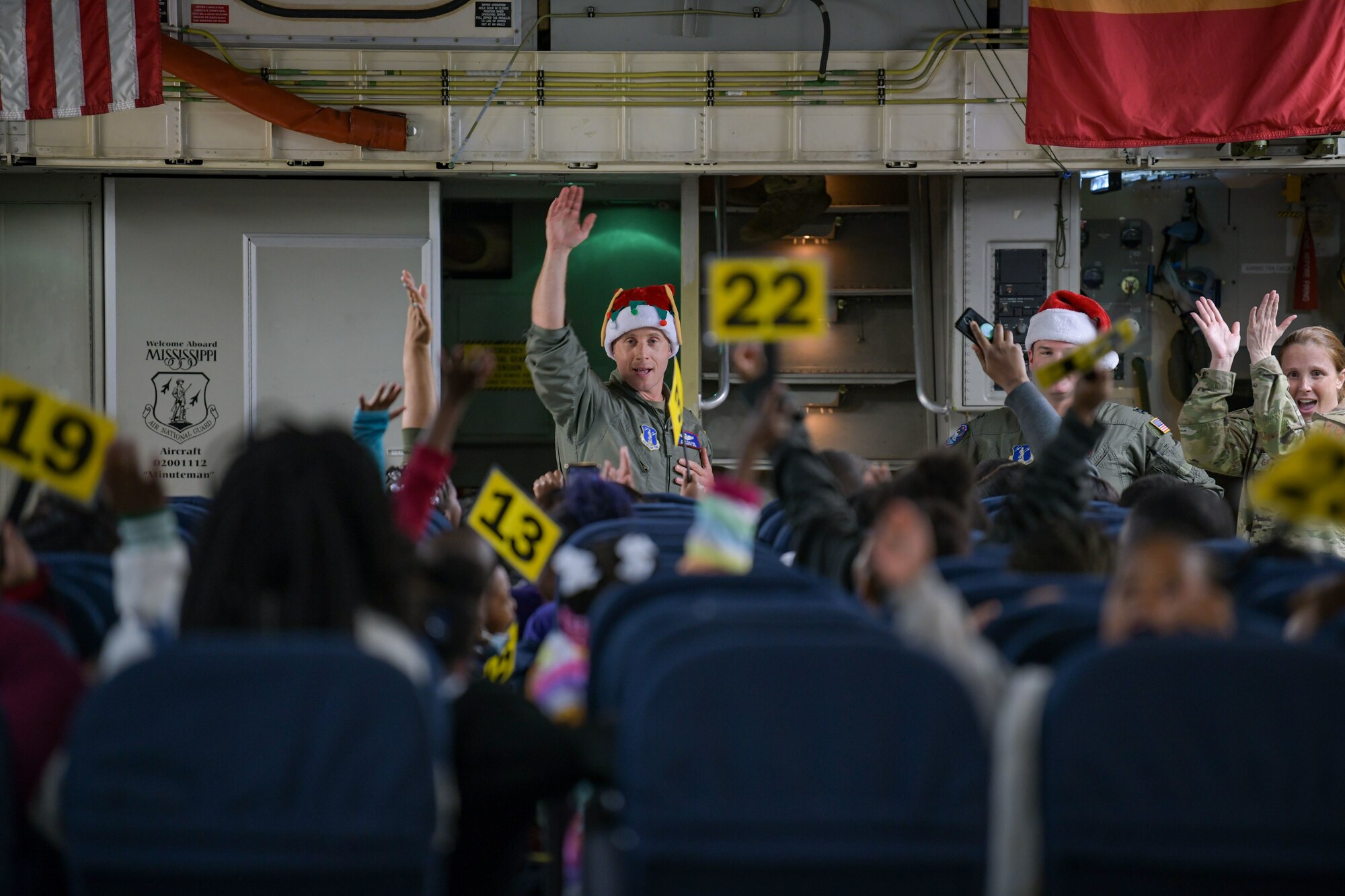 Salvation Army Angel Tree Children disembark from a C-17 Globemaster III at Flight to the North Pole, an annual partnership between the 172nd Airlift Wing, the Jackson, Mississippi Metro Area Salvation Army and the local community. (U.S. Air National Guard photo by Staff Sgt. Jared Bounds)