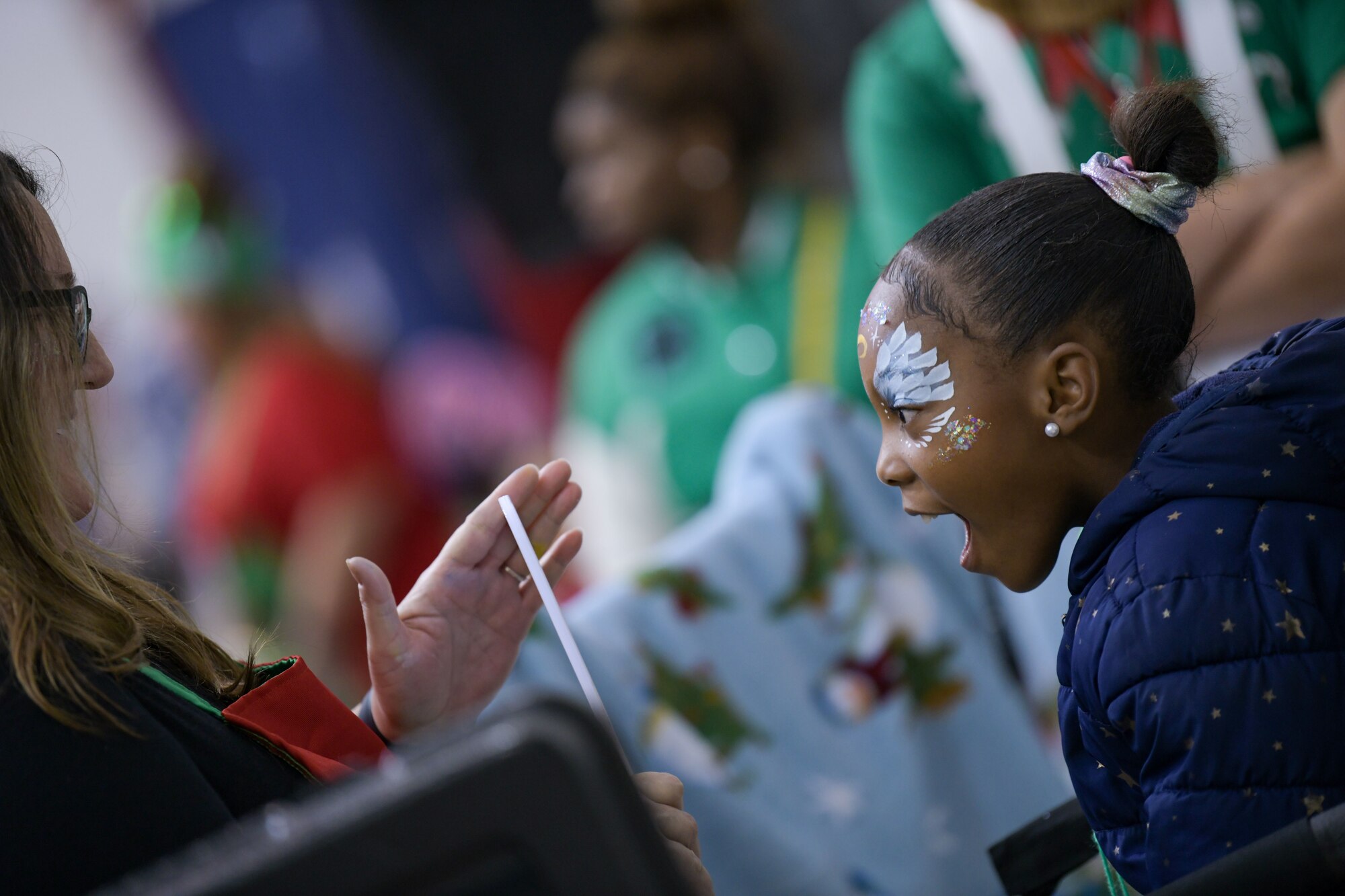 A Salvation Army Angel Tree Child marvels at her reflection at the face-painting station at Flight to the North Pole, an annual partnership between the 172nd Airlift Wing, Jackson, Mississippi, the Jackson, Mississippi Metro Area Salvation Army and the local community. U.S. Air National Guard photo by Staff Sgt. Jared Bounds.