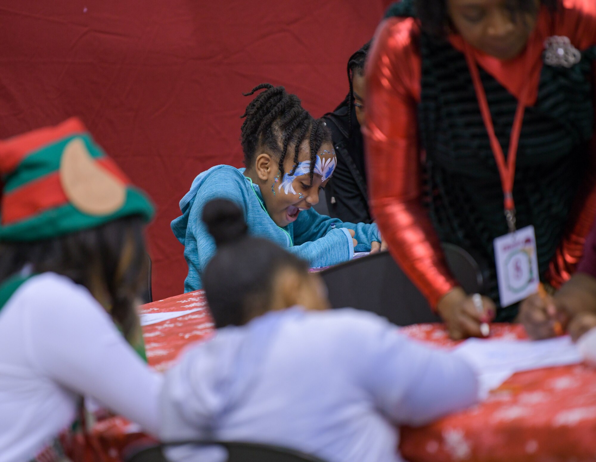A Salvation Army Angel Tree Child takes part in the coloring station at Flight to the North Pole, an annual partnership between the 172nd Airlift Wing, Jackson, Mississippi, the Jackson, Mississippi Metro Area Salvation Army and the local community. U.S. Air National Guard photo by Staff Sgt. Jared Bounds.