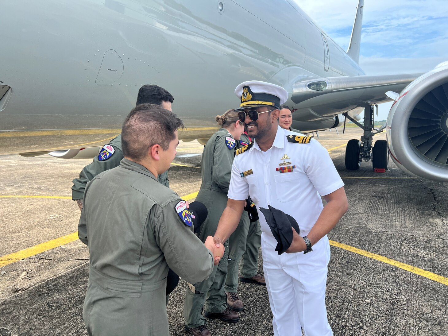 (230124-N-FY142-0003) COLOMBO, Sri Lanka (Jan. 24, 2023) – Lt. Cmdr. Harischandra presents Patrol Squadron (VP) 10 and Combat Aircrew 5 with hats as a token of appreciation for their involvement in the Sri Lanka Cooperation Afloat Readiness and Training/Marine Exercise. VP-10 is currently operating from Kadena Air Base in Okinawa, Japan. The squadron conducts maritime patrol and reconnaissance, as well as theater outreach operations, as part of a rotational deployment to the U.S. 7th Fleet area of operations. (U.S. Navy photo by Lt. j.g. Brian DePaola)