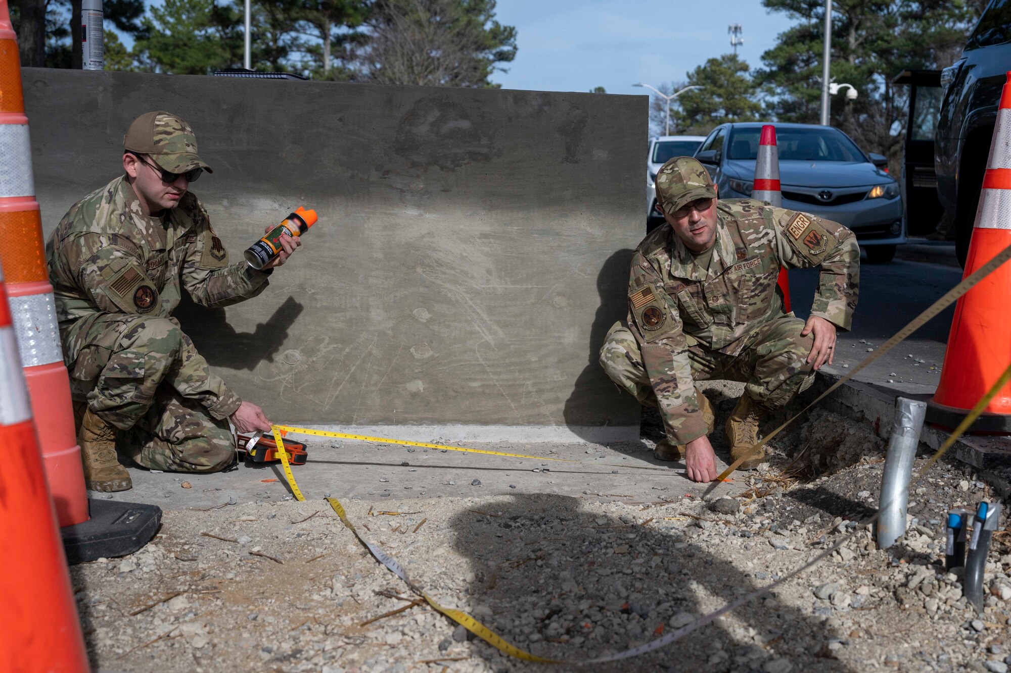 Tech. Sgt. Brian Ashworth and Paul Walker, both 4th CES pavements and equipment technicians, position a pre-engineered building during a sight survey at Seymour Johnson Air Force Base, North Carolina, Jan. 3, 2023. The PEB was positioned as a model building in order to properly measure clearance for passing vehicles after the gate’s update. (U.S. Air Force photo by Senior Airman Kevin Holloway)