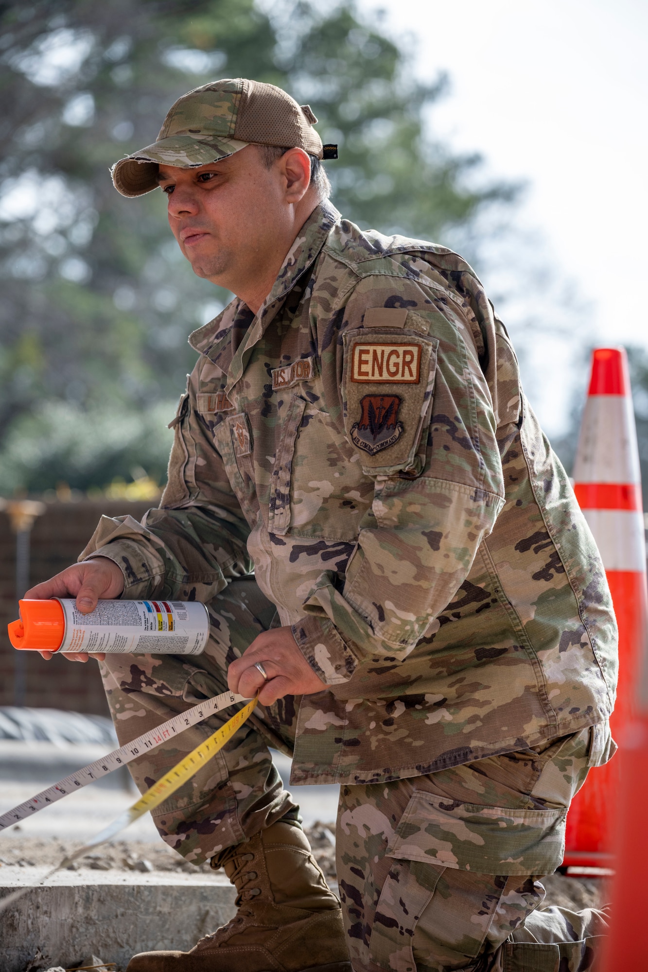 Tech. Sgt. Brian Ashworth and Paul Walker, both 4th CES pavements and equipment technicians, position a pre-engineered building during a sight survey at Seymour Johnson Air Force Base, North Carolina, Jan. 3, 2023. The PEB was positioned as a model building in order to properly measure clearance for passing vehicles after the gate’s update. (U.S. Air Force photo by Senior Airman Kevin Holloway)