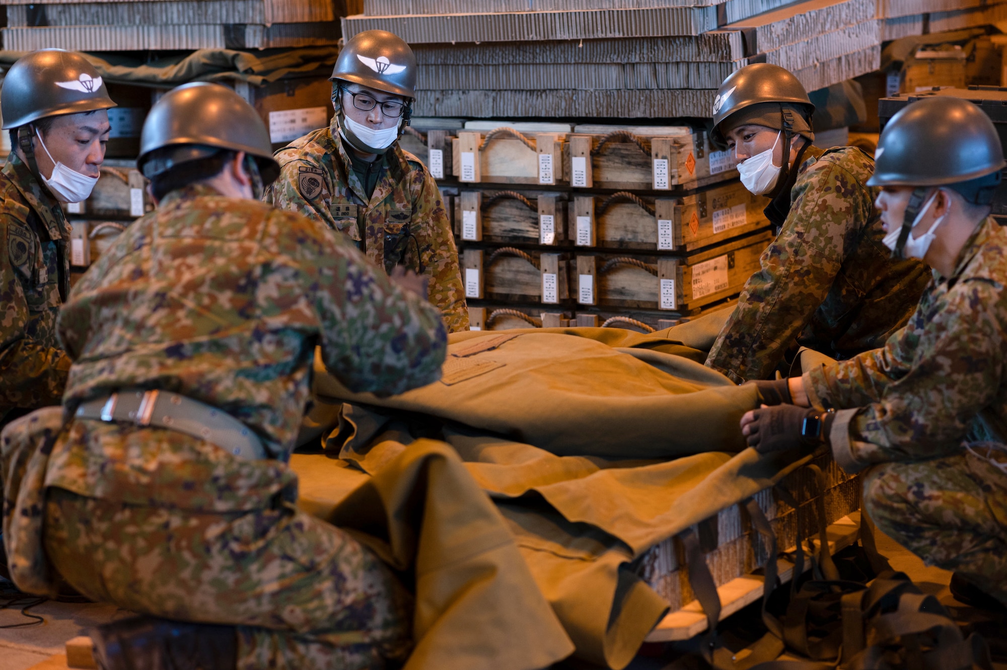 Soldiers from the Japan Ground Self-Defense Force build a Containerized Delivery System bundle