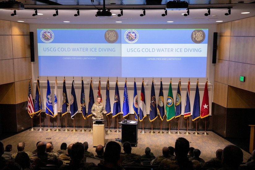 Chief Warrant Officer Sean Eversole, a Coast Guard liaison, presents the capabilities and limitations of USCG cold water ice diving to representatives of the National Guard Arctic Interest Council during their quarterly meeting at Camp Ripley Training Center, Minnesota, Jan. 25, 2023.