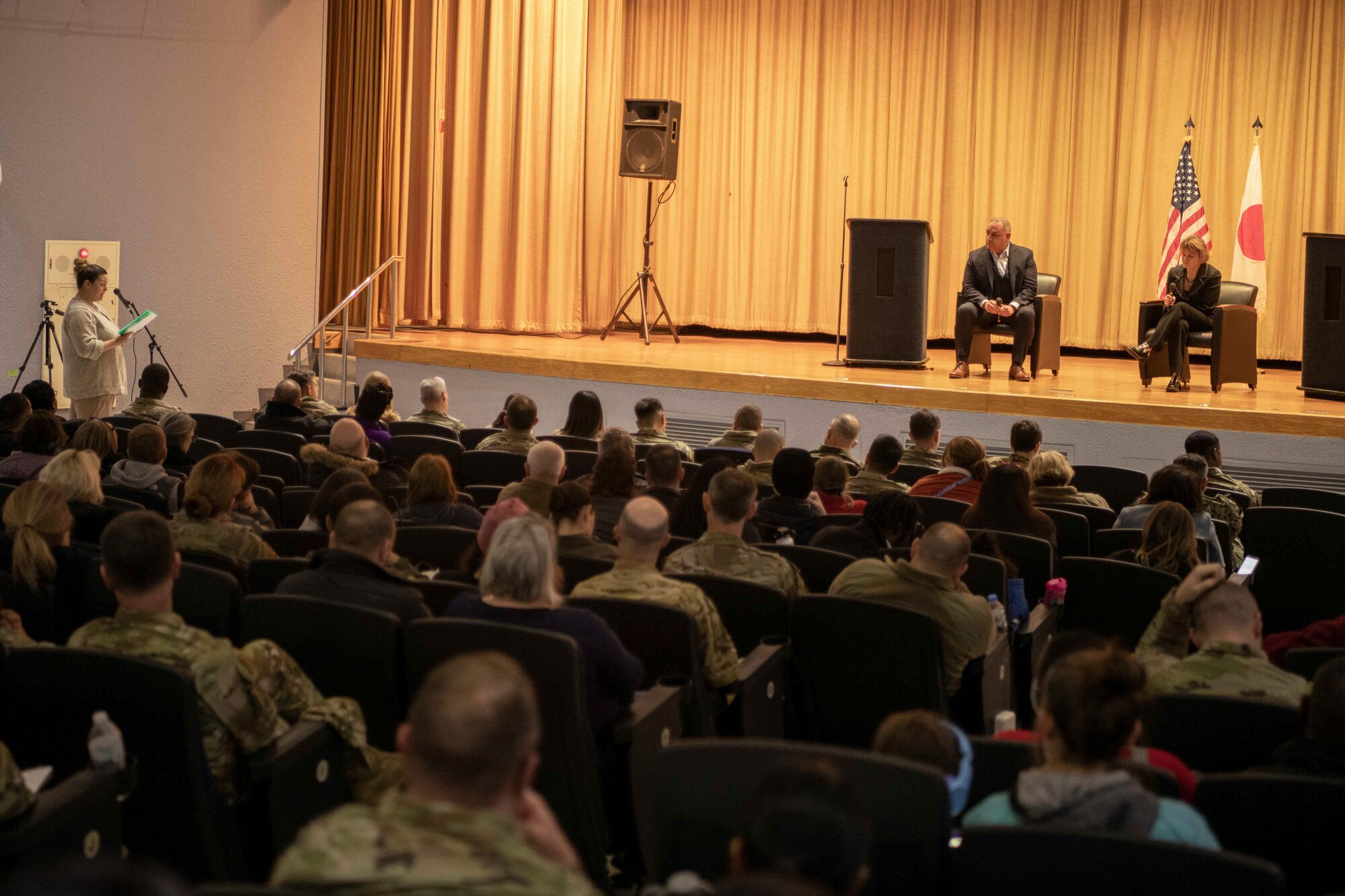 A member of Yokota community asks Gilbert Cisneros Jr., Under Secretary of Defense for Personnel and Readiness, left, and Seileen Mullen, Acting Assistant Secretary of Defense for Health Affairs, a question during a town hall at Yokota Air Base, Japan, Jan. 30, 2023.