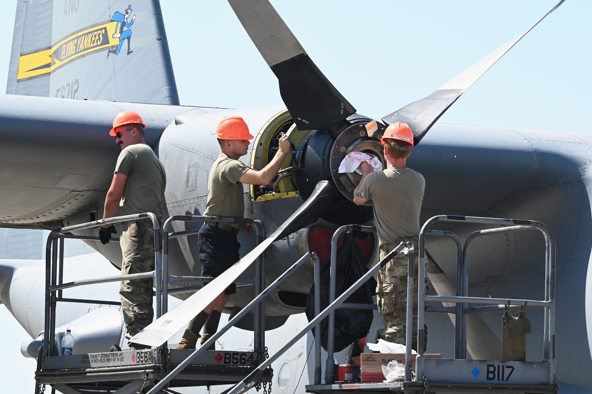 Tech. Sgt. Dan Doyle, Staff Sgt. Nicholas Zamsky, and Staff Sgt. Peter Chase, propulsion technicians with the 75th Expeditionary Airlift Squadron, work on attaching the first of four replacement props for a C-130H at Camp Lemonnier, Djibouti, October 20, 2022. Replacing these props allows the squadron to continue its mission in providing reliable intra-theater airlift operations across a 12-country area of responsibility. (U.S. Air Force photo by Tech. Sgt. Jayson Burns)