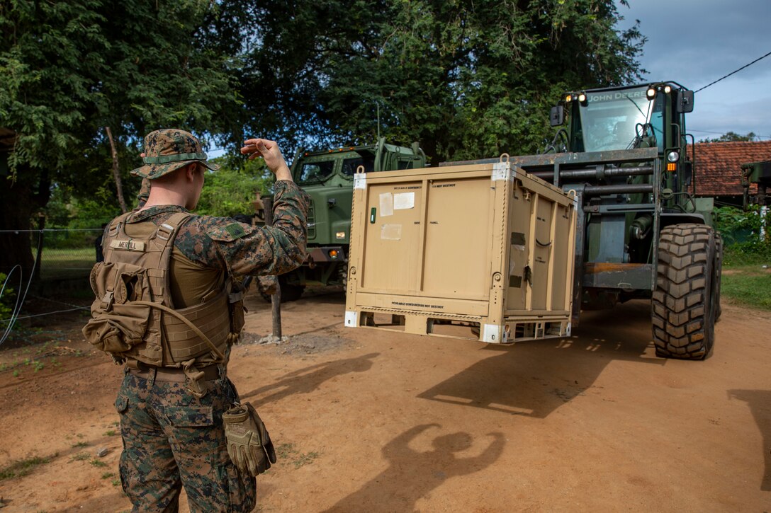 MULLIKULAM, Sri Lanka (Jan. 23, 2023) – U.S. Marine Corps Cpl. Austin Merrill, a heavy equipment operator with Combat Logistics Battalion 13, 13th Marine Expeditionary Unit, directs a 624K tractor rubberized wheel articulated steering multipurpose during a Humanitarian Assistance and Disaster Relief exercise, Jan. 23 in Mullikulam. CARAT/MAREX Sri Lanka is a bilateral exercise between Sri Lanka and the United States designed to promote regional security cooperation, practice humanitarian assistance and disaster relief, and strengthen maritime understanding, partnerships, and interoperability. In its 28th year, the CARAT series is comprised of multinational exercises, designed to enhance U.S. and partner forces’ abilities to operate together in response to traditional and non-traditional maritime security challenges in the Indo-Pacific region. (U.S. Marine Corps photo by Sgt. Brendan Custer)