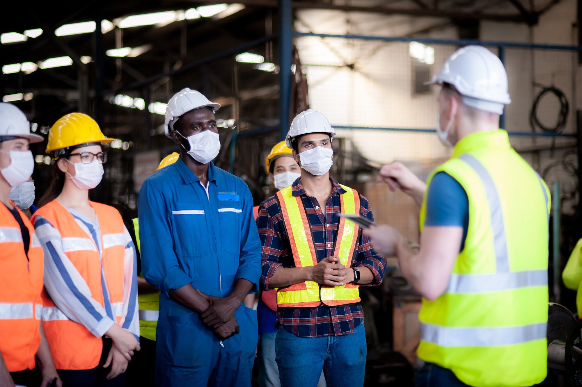 photo shows group of people in safety equipment talking to each other.