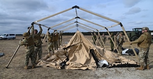 Airmen from the 621st Contingency Response Squadron set up tents with members from the Royal Canadian Air Force during Exercise Jersey Devil on Jan. 11, 2023, at Joint Base McGuire-Dix-Lakehurst, N.J.