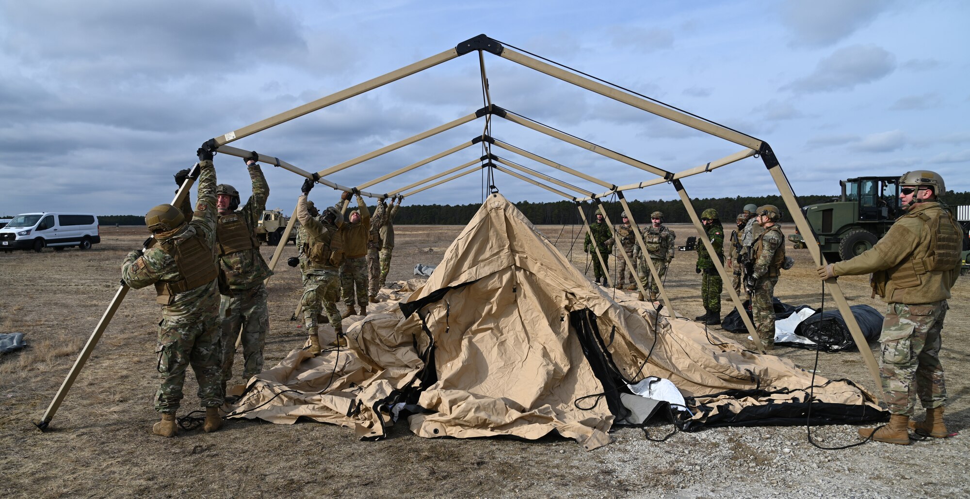 Airmen from the 621st Contingency Response Squadron set up tents with members from the Royal Canadian Air Force during Exercise Jersey Devil on Jan. 11, 2023, at Joint Base McGuire-Dix-Lakehurst, N.J.