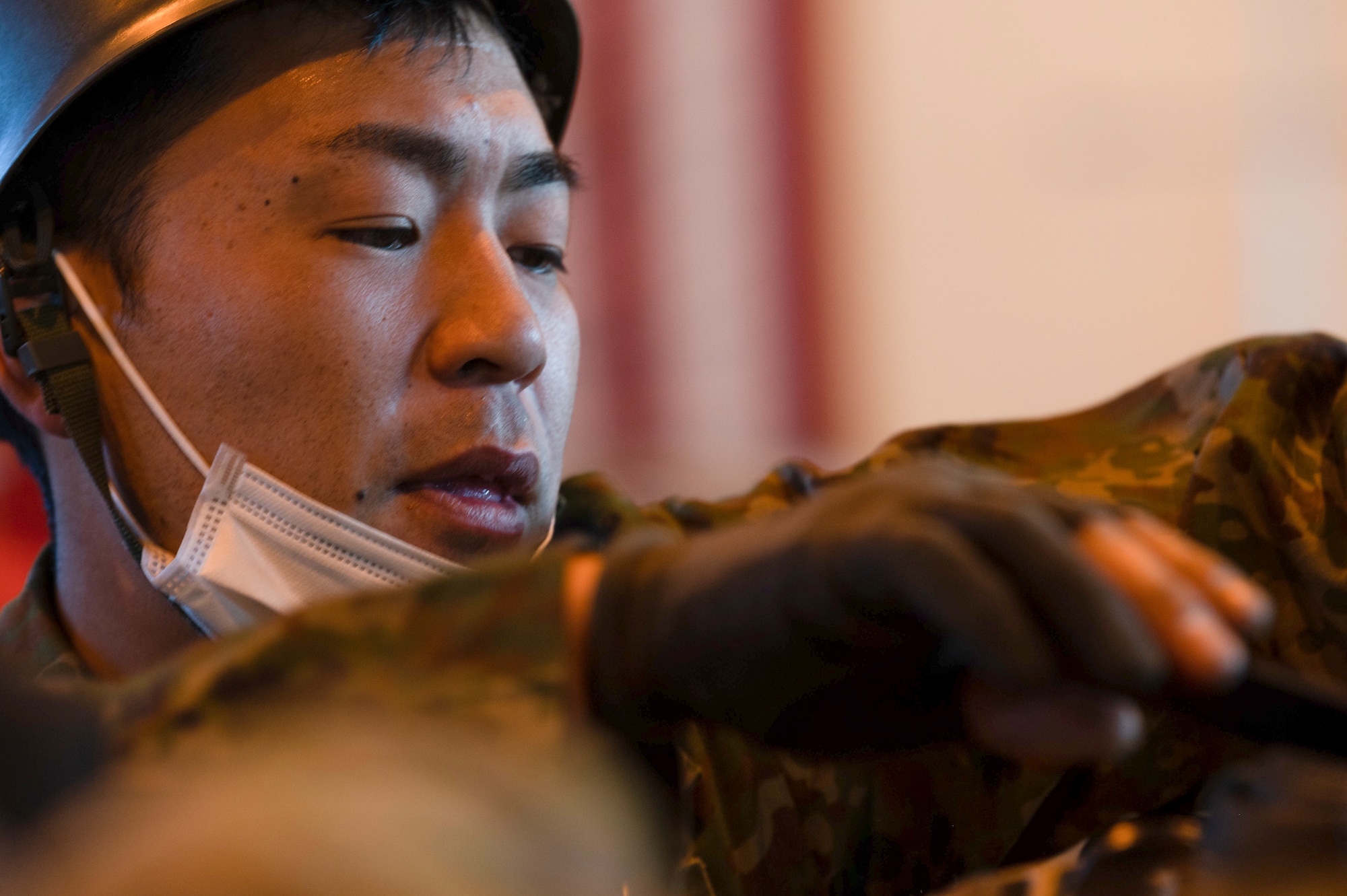 A soldier from the Japan Ground Self-Defense Force secures a Containerized delivery System bundle
