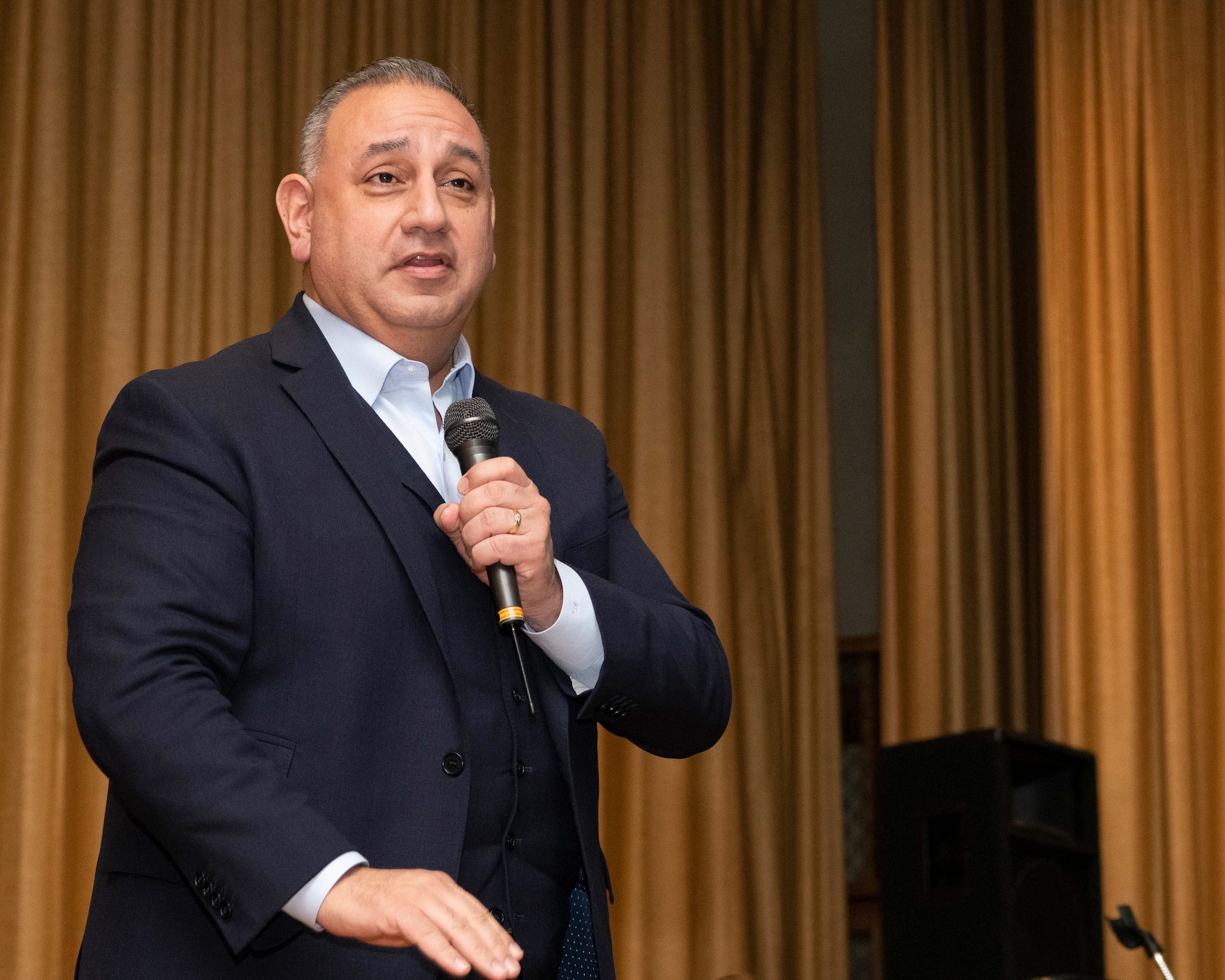 Gilbert Cisneros Jr., Under Secretary of Defense for Personnel & Readiness, answers a question from a member of Yokota community during a town hall at Yokota Air Base, Japan, Jan. 30, 2023.