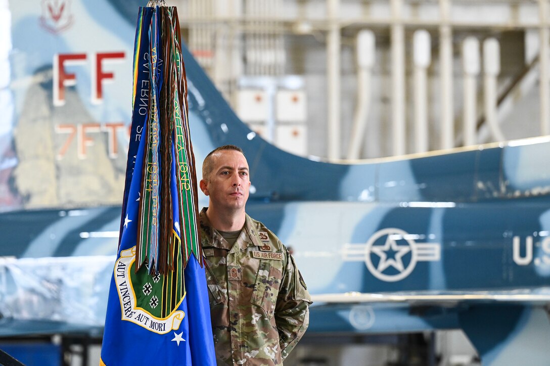 Airman holds flag.