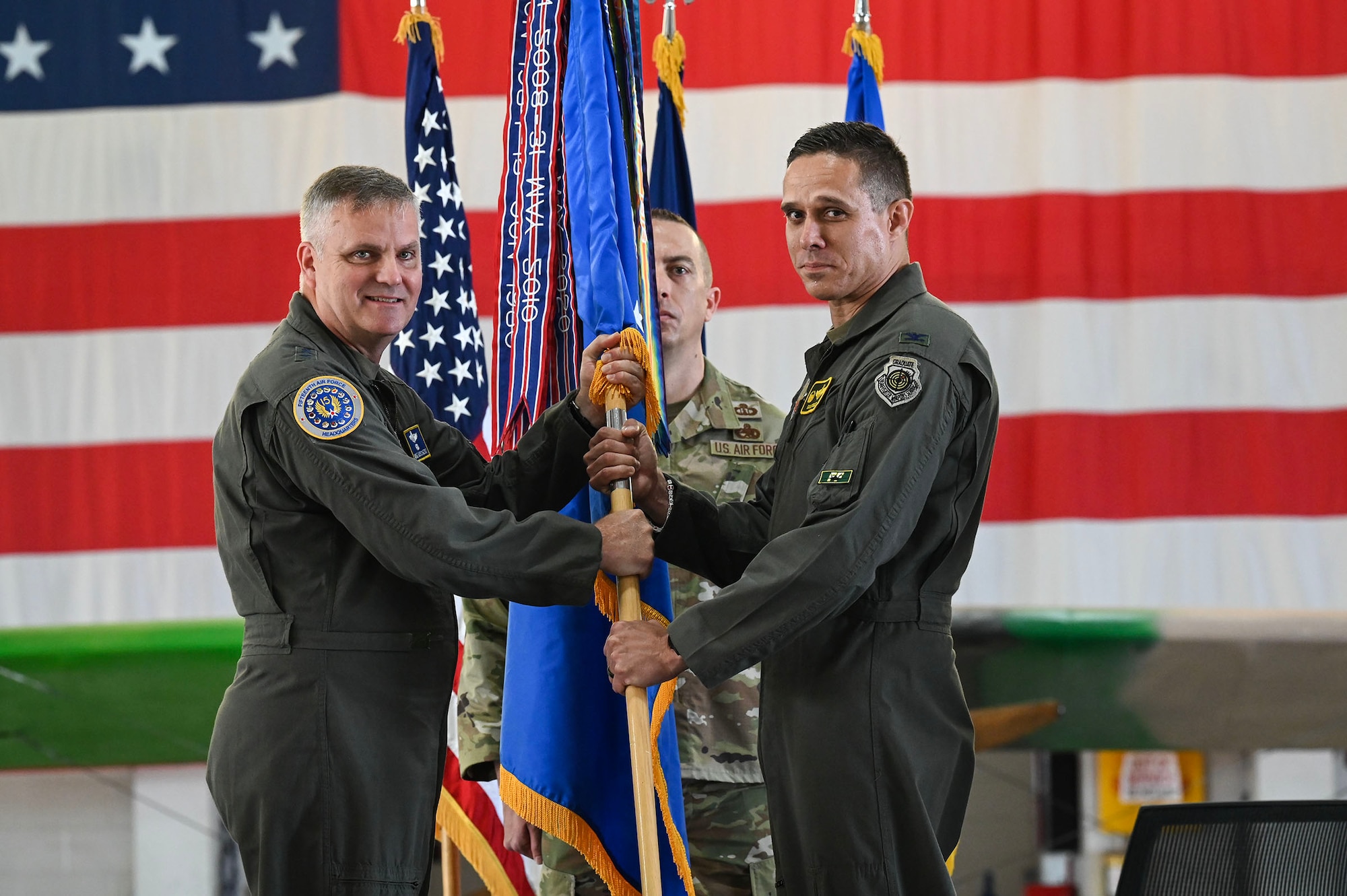 Airmen holds flag.