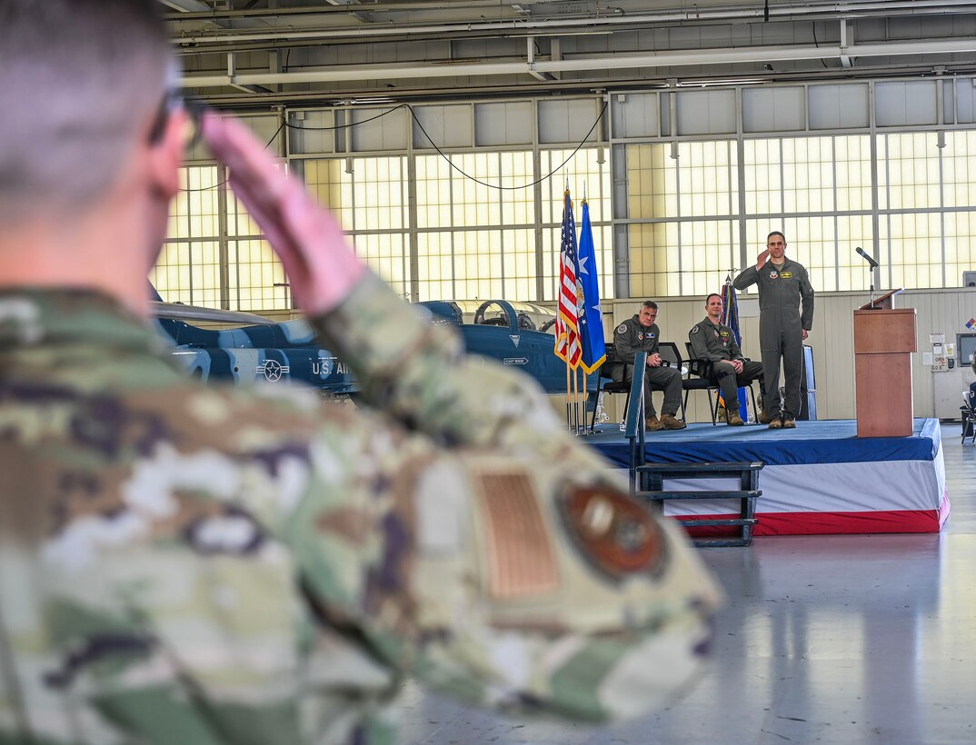 Airmen render salute.